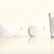 Citric acid granules transforming into an effervescent tablet dissolving in water